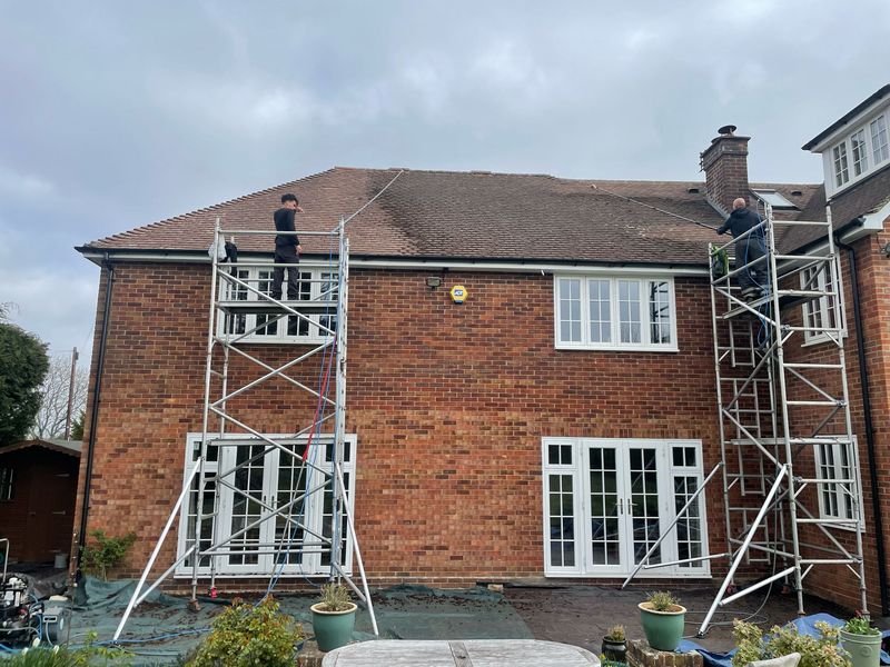 Roof cleaning carried out safely from scaffold towers by The Roof Moss Cleaners in Bordon